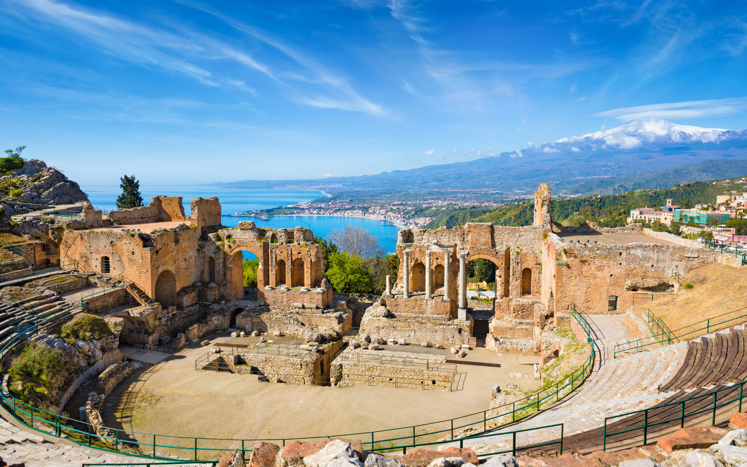 ancient greek theatre in taormina on background of etna volcano,